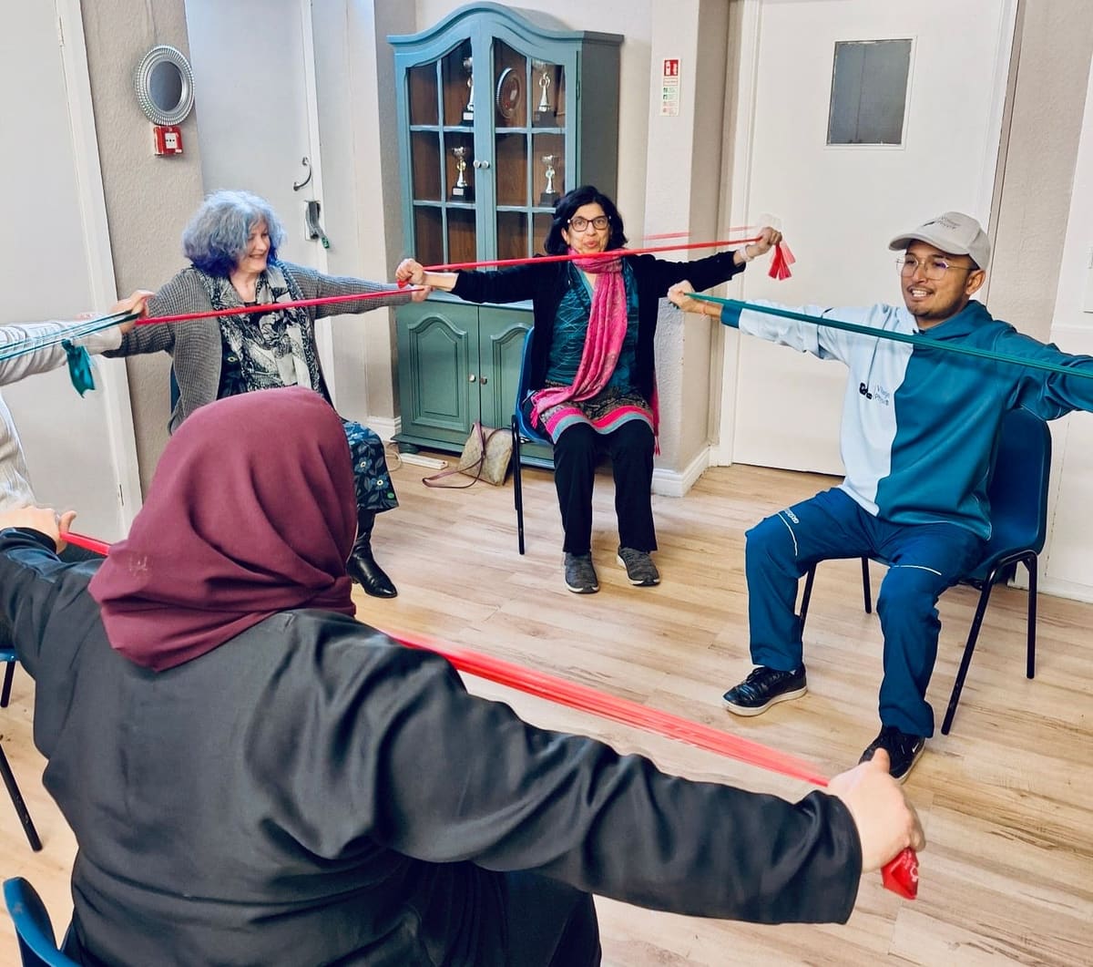 Women taking part in a seated group exercise session